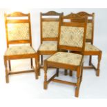 A set of four Old Charm oak single dining chairs, with floral carved crest rails, floral tapestry