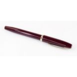 A Sheaffer fountain pen, in burgundy with banding and shaped clip, and partially enclosed nib,
