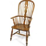 A 19thC oak and elm Windsor chair, with a pierced vase shaped splat, solid saddle seat, raised on