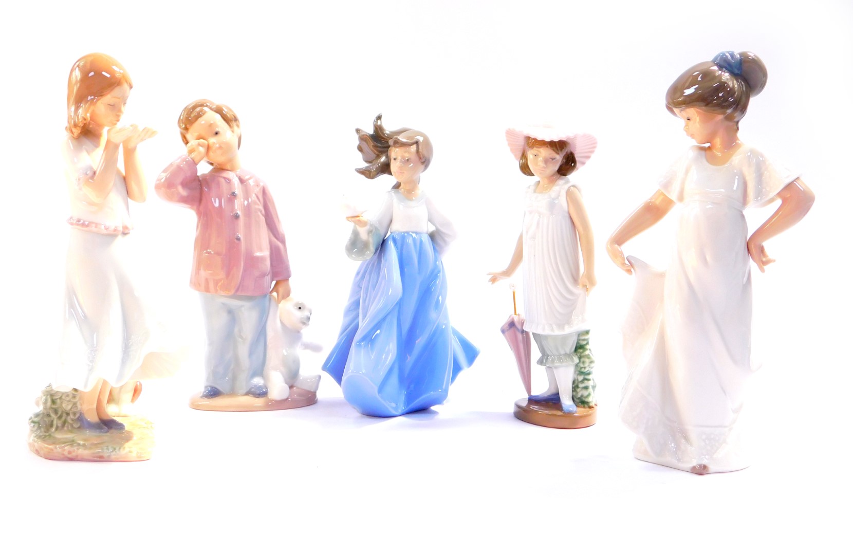 A Lladro porcelain figure modelled as Whispering Breeze, boxed, and Nao figures, modelled as a