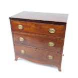 A George III mahogany chest, of three graduated drawers with boxwood line inlay, oval plate