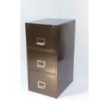 A brown metal three drawer filing cabinet, with keys, 100.5cm H, 47cm W, 51.5cm D.