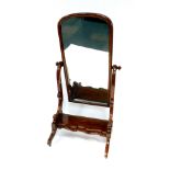 A Victorian mahogany cheval mirror, the domed mirror within scrolling supports, over a serpentine