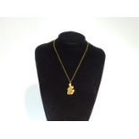 A 9ct gold "½oz" pendant, of abstract polished and textured form, on a curb link neck chain, with