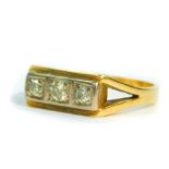 A diamond three stone ring, in a rectangular two colour setting, approximately 1/4 carat, size Q,