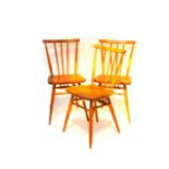 A set of three Ercol elm and beech stick back kitchen chairs, model 391.