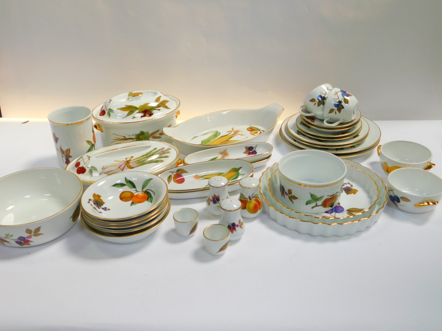 A group of Royal Worcester oven to table ware decorated in the Evesham pattern, including flan