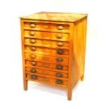 An early 20thC pine compositor's chest, of eight drawers, raised on square legs, 100.5cm H, 70.5cm