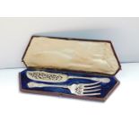 A pair of silver plated King's pattern fish servers, with pierced and engraved foliate scroll