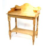 A Victorian style pine washstand, with shaped splash back and scrolling sides to the top, and with a