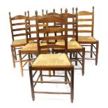 A set of six oak rush seated ladder back chairs.