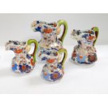 Four graduated ironstone hydra jugs, of octagonal form, painted with flowers, marked to base