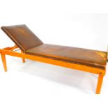 An early 20thC beech framed doctor's examination couch, the top with overstuffed brown American