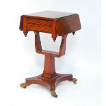 A William IV flame mahogany drop flap work table, with two fitted drawers, raised on a U shaped