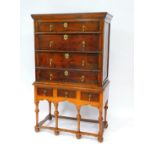 A mid 18thC oak chest on stand, the outswept pediment over four graduated drawers, the stand with