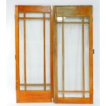 A pair of early 20thC glazed oak internal doors, 208cm H, 81cm W.