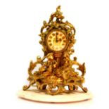 A French brass mantel clock by Rocha and Meirelles, Paris, the circular enamel dial bearing coat