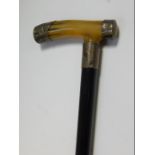 A George V ebony walking stick, with horn handle, with silver caps and ferrule, foliate engraved