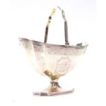 A George III silver sugar basket, of fluted boat shaped pedestal form, with bright cut engraving,