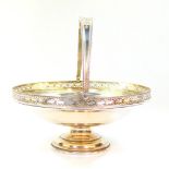 A George V silver pedestal basket, of circular form, with a pierced gallery and swing handle,