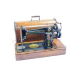 A Singer Model 66K sewing machine, decorated with Egyptianesque motifs, serial no F830375, oak