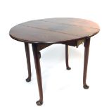 A George III figured mahogany oval drop leaf occasional table, supported on four slender tapered