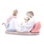 M106- A Lladro porcelain figure group modelled as a lady in recumbent pose cradling a baby, with her