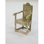 An early 20thC silver miniature model of a Wainscot chair, engraved decoration, import and further