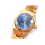 A Rolex Oyster Perpetual lady's 18ct gold wristwatch, having a blue lustre dial with centre seconds,