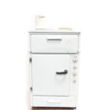 An early 1960's Belling electric cooker, in white stove enamel, with a three hob top, grill pan