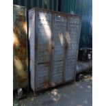 A mid 20thC painted cast metal three door sports locker, 179cm H, 120cm W, 50cm D.