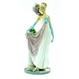 A Lladro porcelain figure of a lady, modelled standing in 1920's costume, against a fluted column