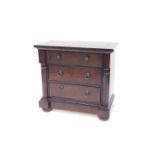 A Chinese Victorian style dark oak bedside chest, of three drawers flanked by demi pilasters, raised