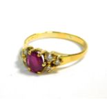 A ruby solitaire ring, with diamond set shoulders in yellow metal, ruby approximately 3/4 carat,