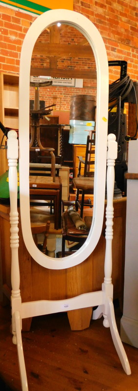 A white painted wooden robing mirror, with an oval framed mirror, raised on a turned wooden frame