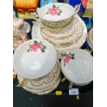 An Imperial porcelain 1950's part dinner service, decorated with roses and gilt flowers,