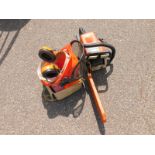 A Stihl 017 petrol chainsaw, with helmet, visor and ear defenders, spare spark plugs, chain spanner,