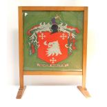 A beech framed wool work heraldic fire screen, with motto 'Semper Paratus', 61cm H, 49cm W.