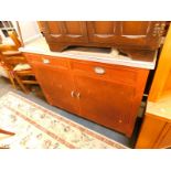 A Russ red painted kitchen cupboard, with a grey melamine top, over two drawers above cupboard