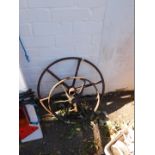 Two six spoke cast iron wheels.