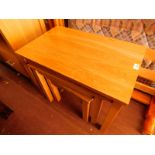 A nest of light oak occasional tables, largest 53.5cm H, 66cm W, 40.5cm D.