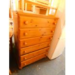 A pine chest of six long drawers, raised on bun feet, 119cm H, 86cm W, 45cm D.