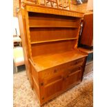 A light oak dresser, the three shelf Delft rack over two drawers above panelled doors, raised on