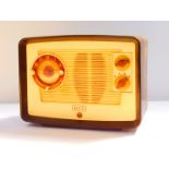 An Ekco brown and cream bakelite clock radio, model A222, 32.5cm wide.