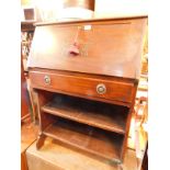 An early 20thC oak student's bureau, the fall flap opening to reveal a single drawer and recesses,