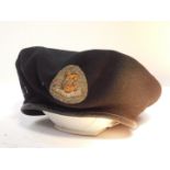 A WWII British military beret, bearing a cap badge for The Royal Dragoons, dated internally 1944.