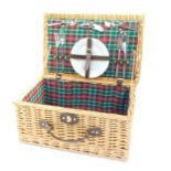 A wicker picnic hamper, partly fitted.