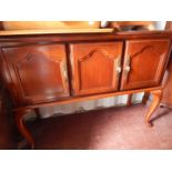 A mahogany sideboard, with three cupboard doors, raised on cabriole legs, 120cm W,