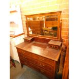 An Edwardian mahogany dressing chest, the swing frame mirror over two small drawers, above two short