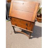 An oak bureau, with fall opening to enclose shelves section, on barley twist legs, 105cm high,